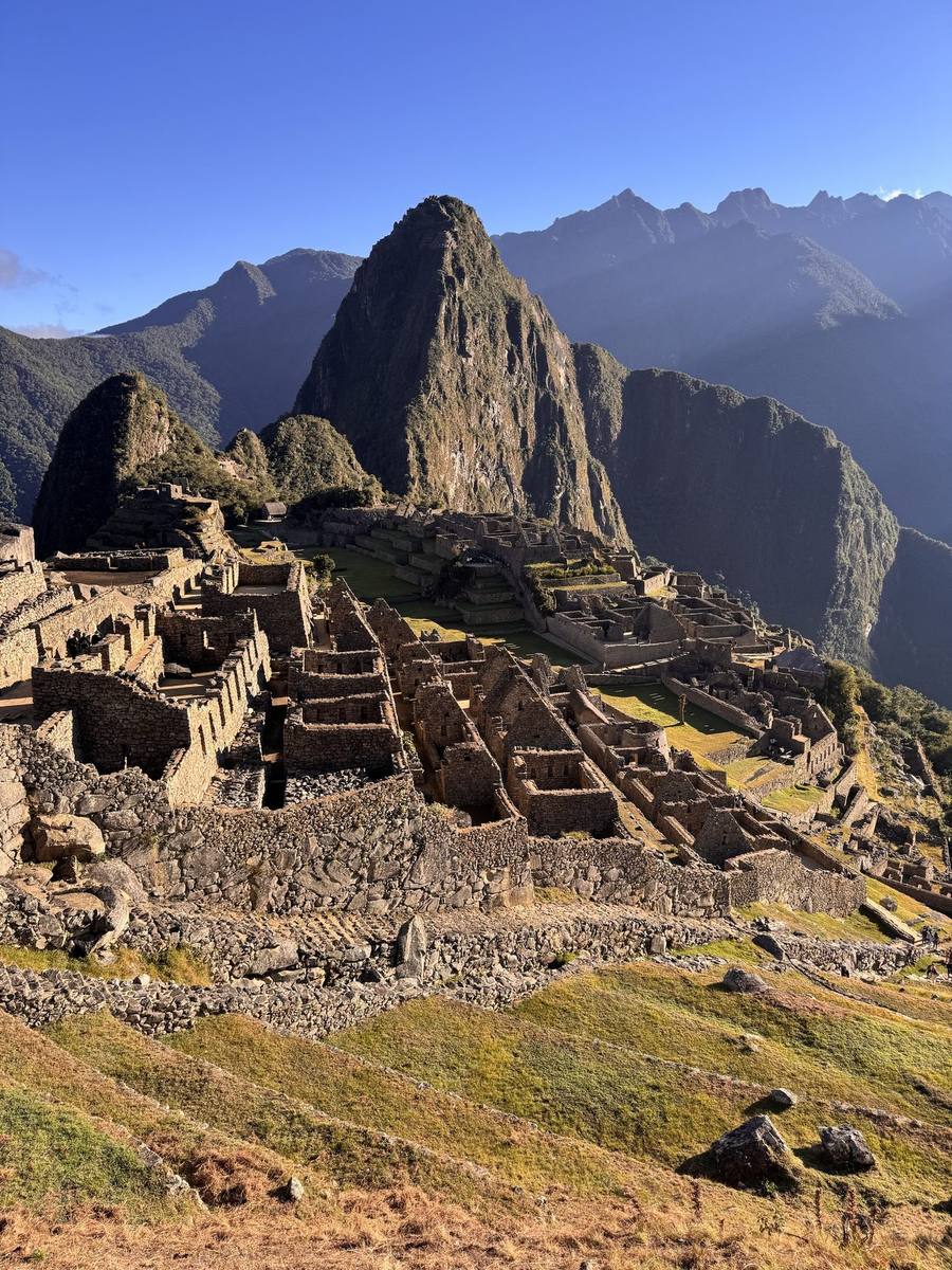Machu Picchu at sunrise, with Huayna Picchu behind the citadel