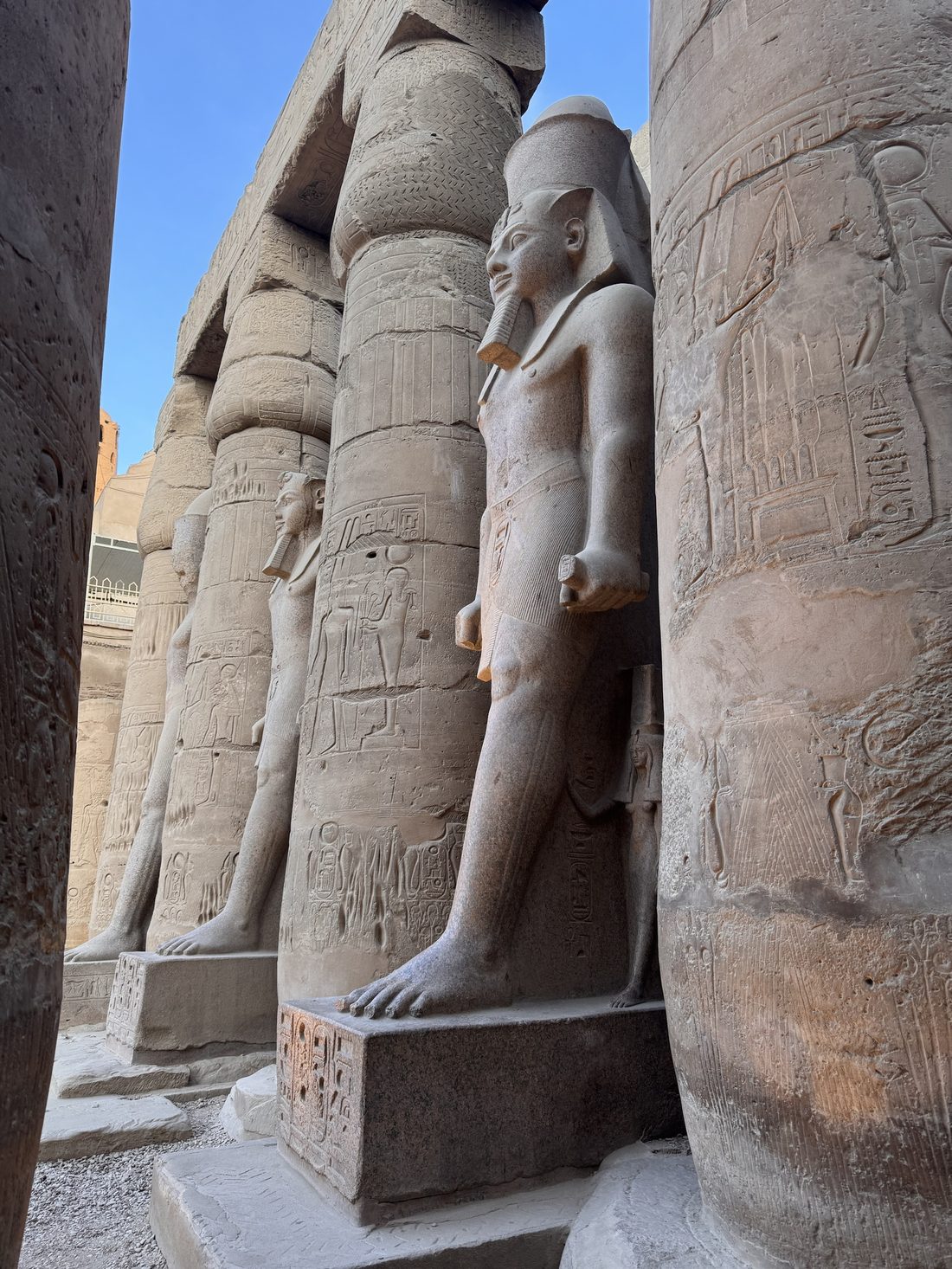 Colossal statues of Ramesses II among the columns of Luxor Temple